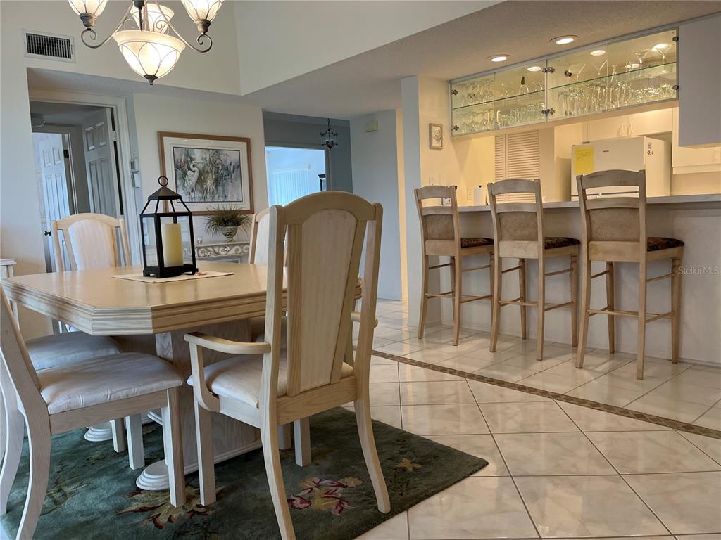 1397 Perico Point Circle, Unit 1397 Bradenton, FL 34209 - Photo 22 of 39 a dining room with furniture and a chandelier