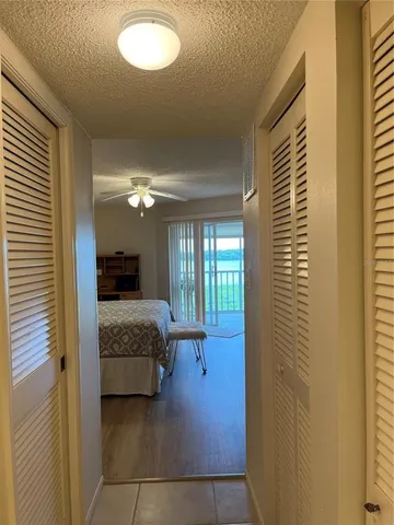 a bedroom with a bed and dresser with window