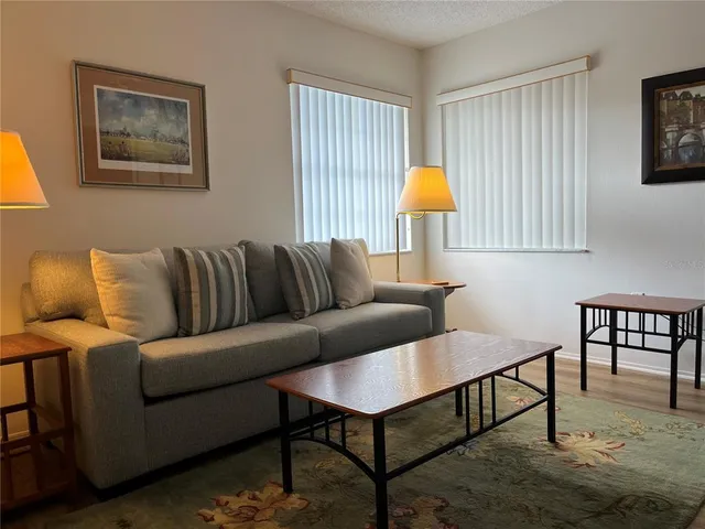a living room with furniture and a lamp