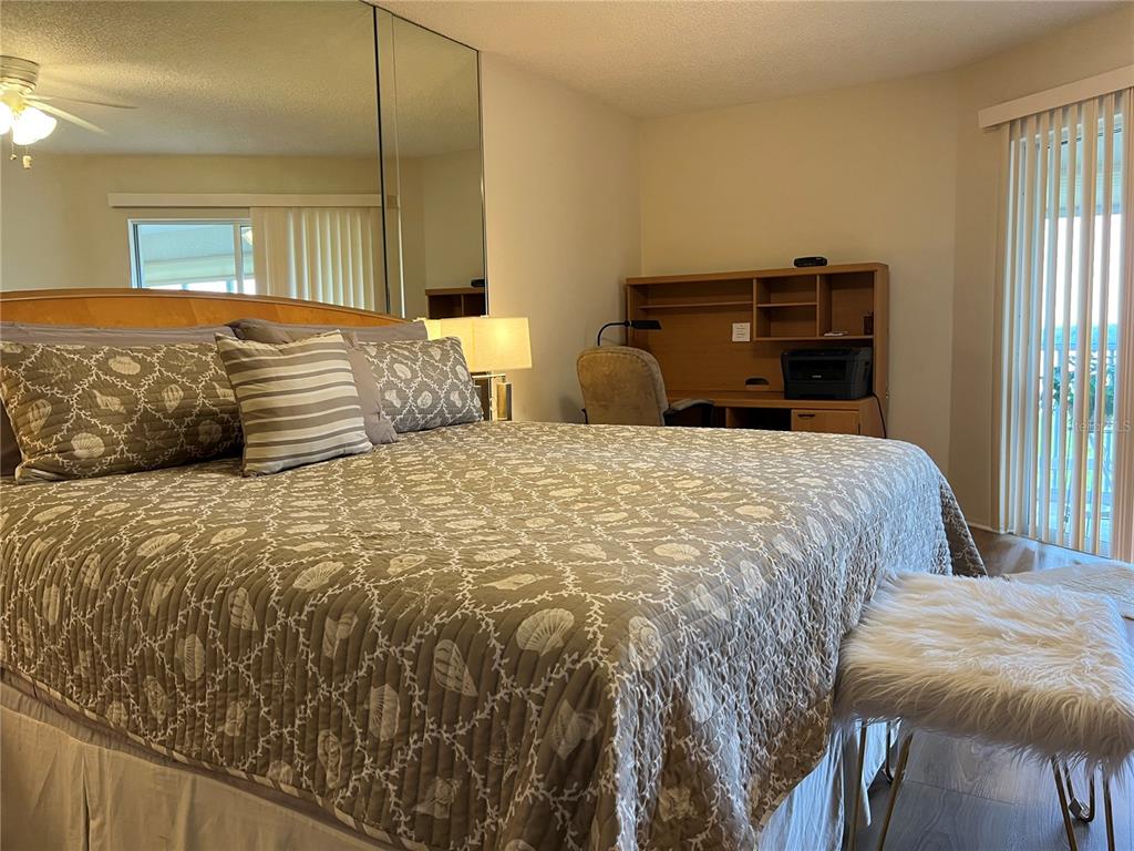 1397 Perico Point Circle, Unit 1397 Bradenton, FL 34209 - Photo 31 of 39 a bedroom with a bed and dresser with window