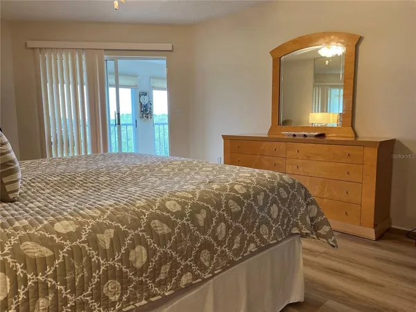 a bedroom with a bed and a mirror