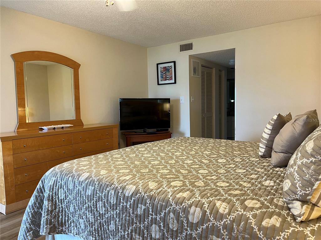 1397 Perico Point Circle, Unit 1397 Bradenton, FL 34209 - Photo 33 of 39 a bedroom with a bed and a mirror