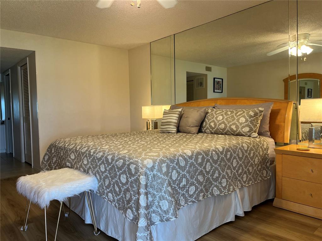 1397 Perico Point Circle, Unit 1397 Bradenton, FL 34209 - Photo 34 of 39 a bedroom with a bed a lamp and a chandelier