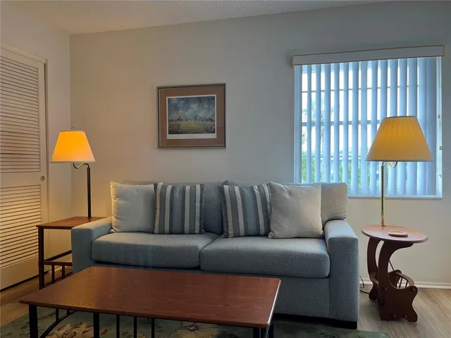 a living room with furniture and a lamp