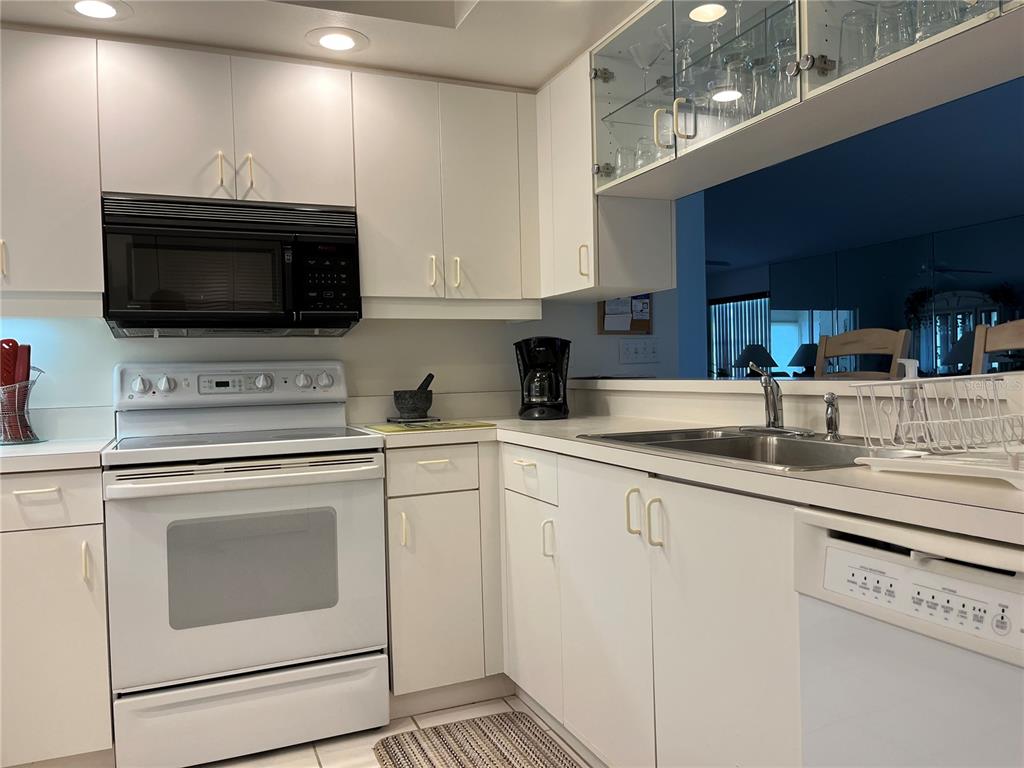 1397 Perico Point Circle, Unit 1397 Bradenton, FL 34209 - Photo 10 of 39 a kitchen with granite countertop a sink stainless steel appliances and cabinets