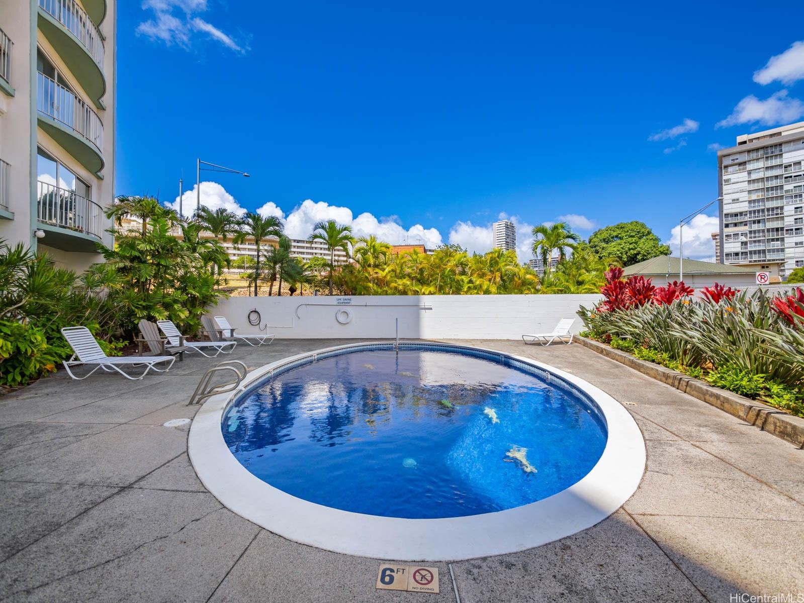 710 Lunalilo Street, Unit 402 Honolulu, HI 96813 - Photo 21 of 24 a view of a swimming pool with an outdoor seating and a potted plant