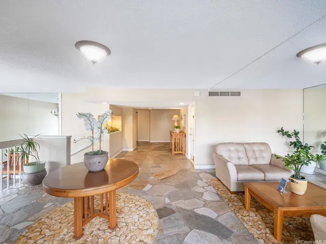 a view of entryway with stairs and a ceiling fan