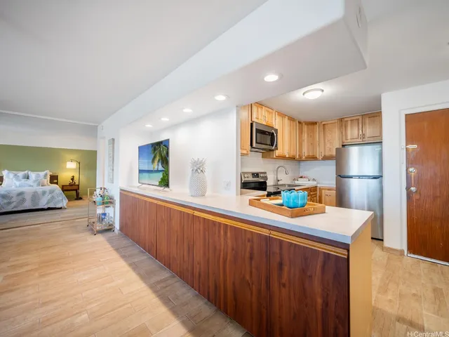 a kitchen that has a lot of cabinets a sink and a refrigerator