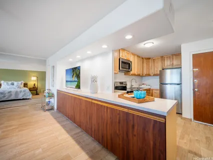a kitchen that has a lot of cabinets a sink and a refrigerator