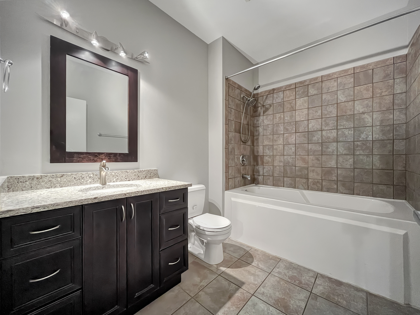 1301 West Madison Street, Unit 201 Chicago, IL 60607 - Photo 13 of 14 a bathroom with a granite countertop sink toilet and shower