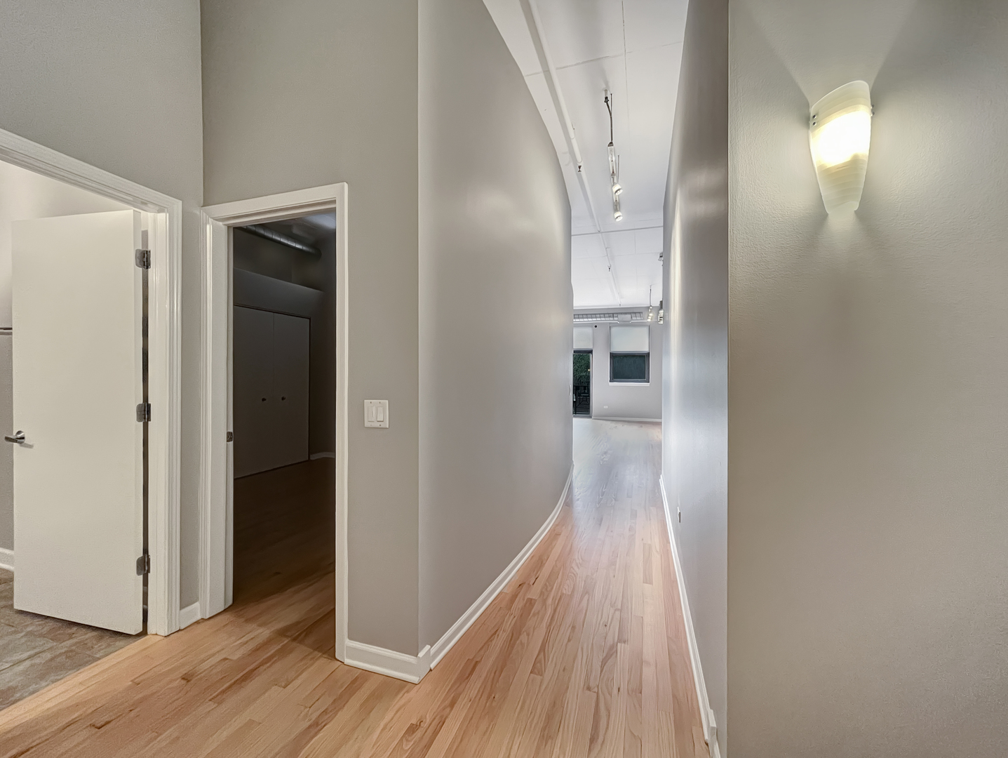 1301 West Madison Street, Unit 201 Chicago, IL 60607 - Photo 2 of 14 a view of a hallway with wooden floor