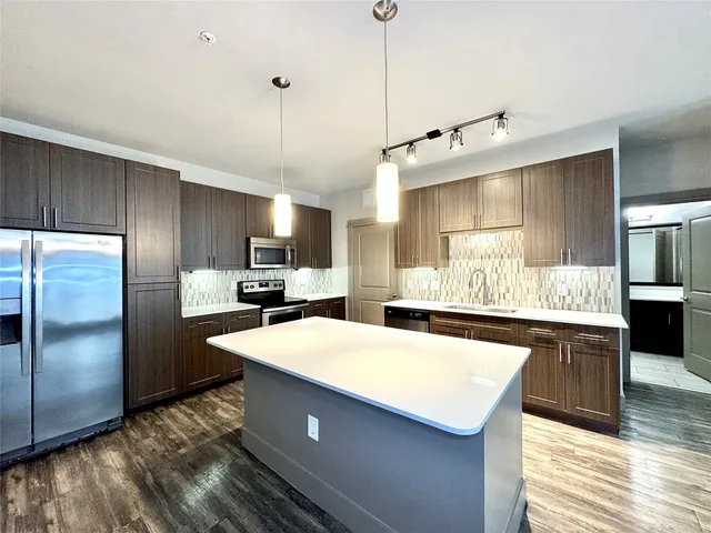 a view of a kitchen with a sink and a window