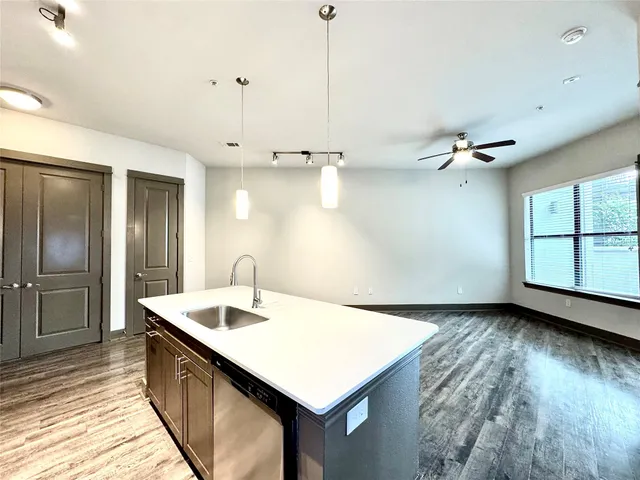 a kitchen with kitchen island a sink appliances and a counter space