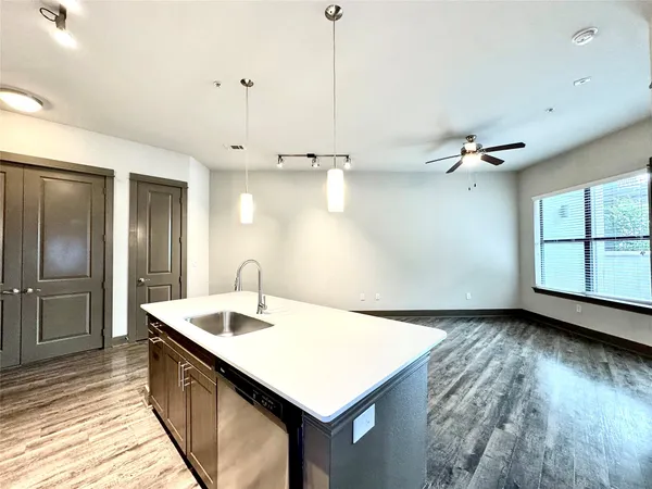 a kitchen with kitchen island a sink appliances and a counter space