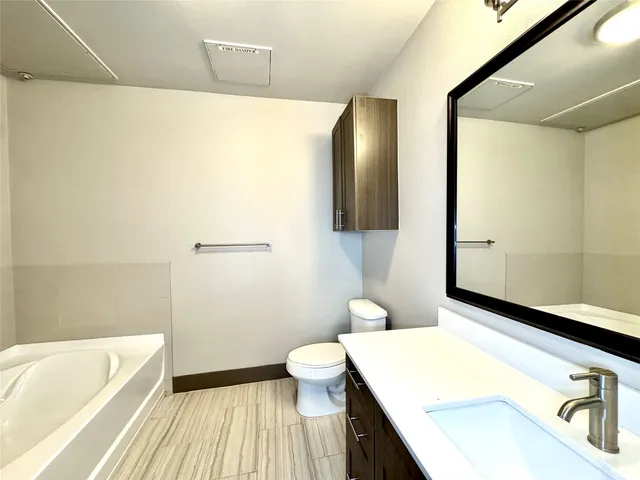 a bathroom with a sink a toilet and a bathtub