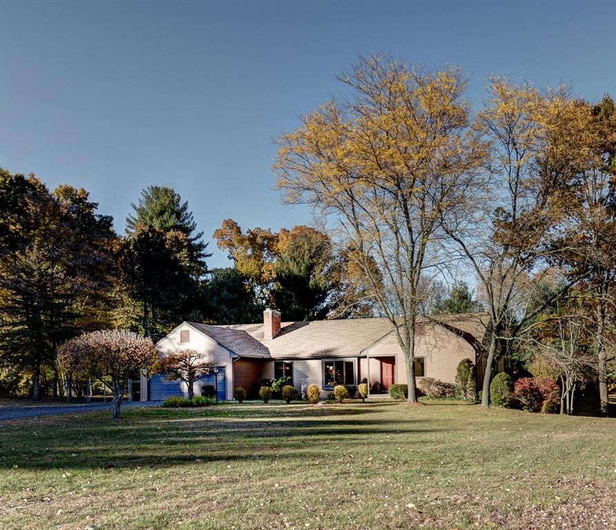 14 Partridge Meadow Road Granby, CT 06035 - Photo 1 of 1 a front view of a house with a garden and trees