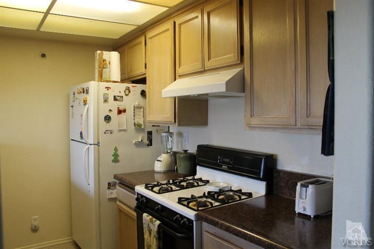 470 West Wooley Road Oxnard, CA 93030 - Photo 13 of 17 a kitchen with stainless steel appliances a refrigerator a stove and a microwave