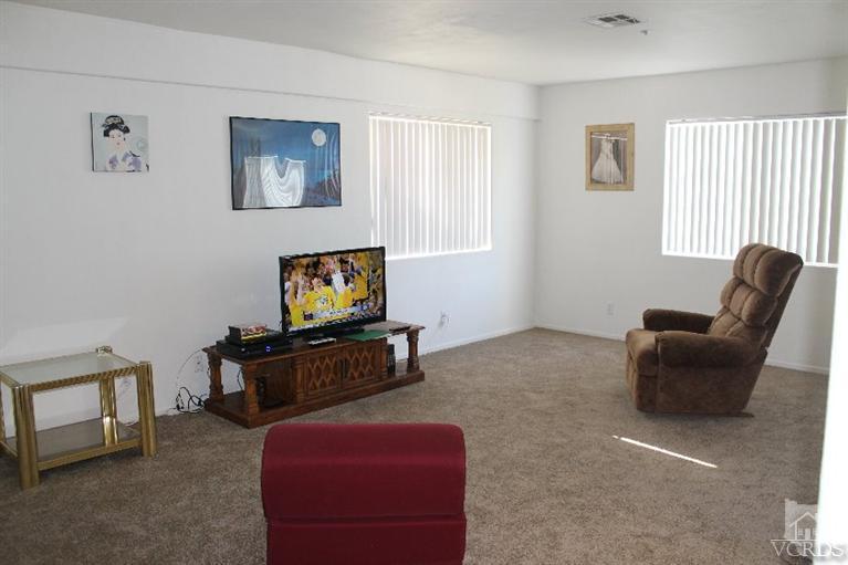 470 West Wooley Road Oxnard, CA 93030 - Photo 3 of 17 a living room with furniture and a flat screen tv