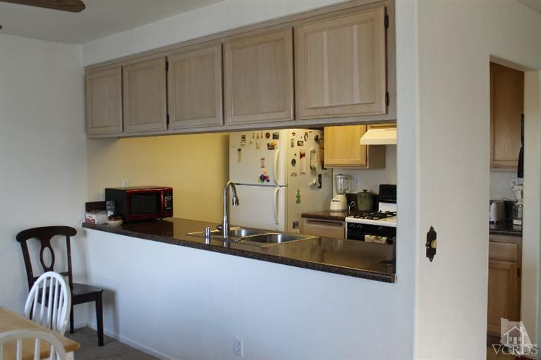 470 West Wooley Road Oxnard, CA 93030 - Photo 4 of 17 a kitchen with stainless steel appliances granite countertop a refrigerator and a stove top oven