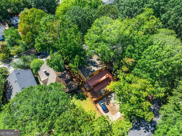 an aerial view of a house with a yard and garden