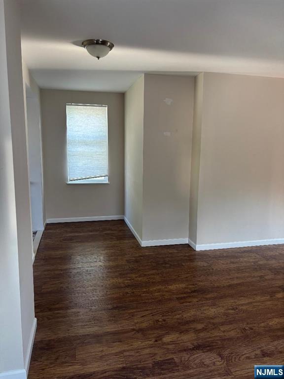 476 Washington Avenue, Unit 2 Hackensack, NJ 07601 - Photo 6 of 9 a view of an empty room with wooden floor and a window
