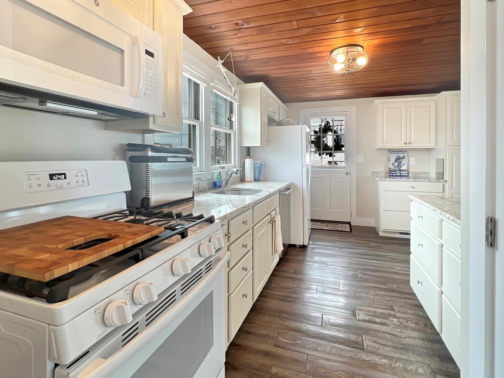 296 Central Avenue Scituate, MA 02050 - Photo 15 of 37 a kitchen with stainless steel appliances granite countertop a stove and a refrigerator