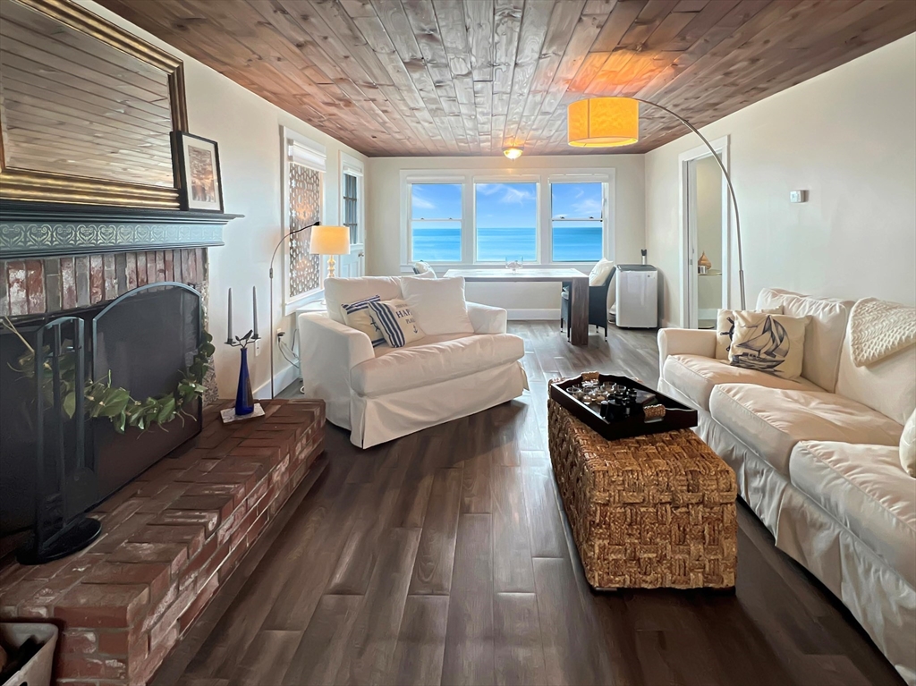 296 Central Avenue Scituate, MA 02050 - Photo 18 of 37 a living room with furniture and a fireplace