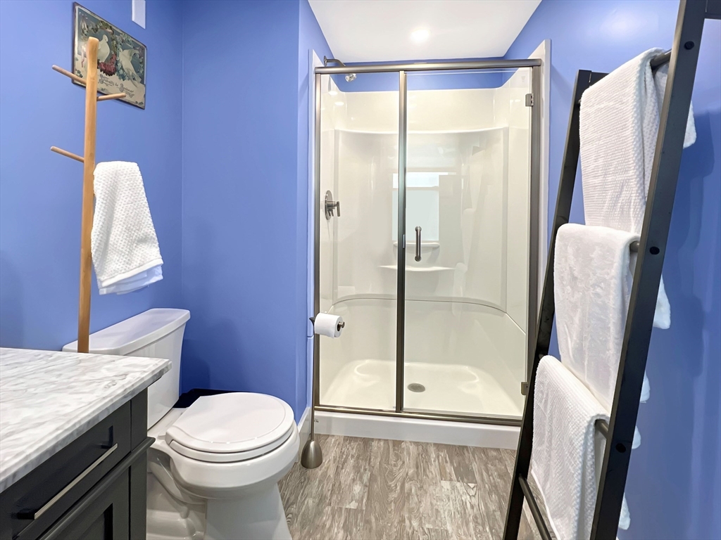 296 Central Avenue Scituate, MA 02050 - Photo 25 of 37 a bathroom with a granite countertop sink toilet and shower