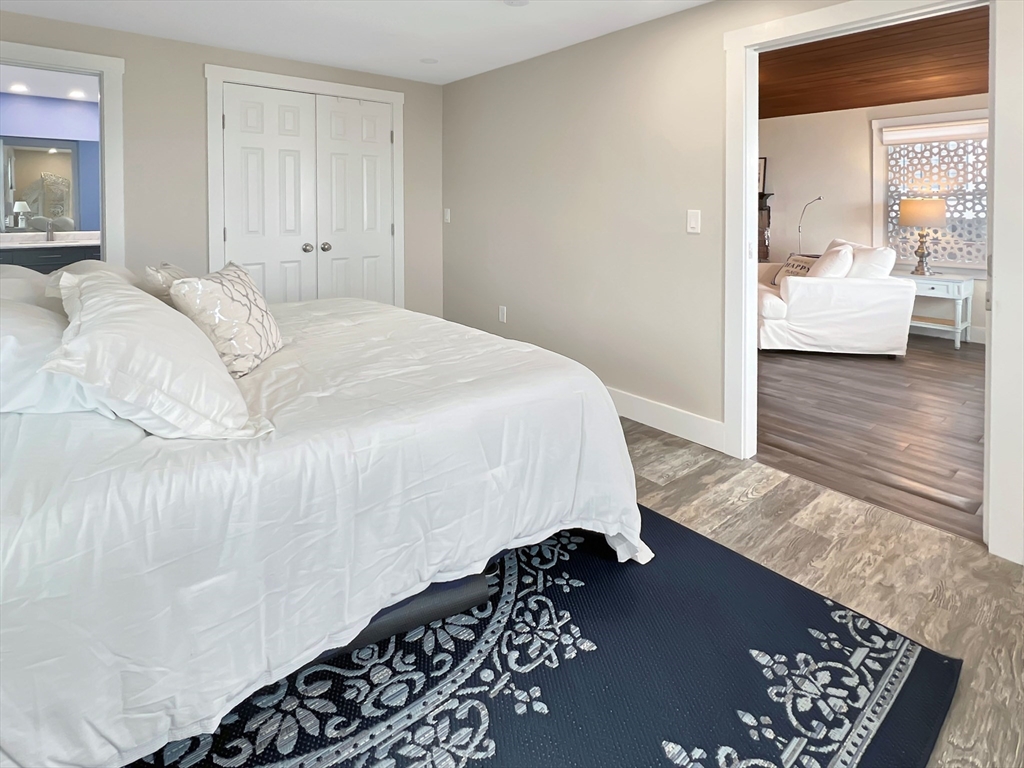 296 Central Avenue Scituate, MA 02050 - Photo 27 of 37 a bedroom with a bed and wooden floor