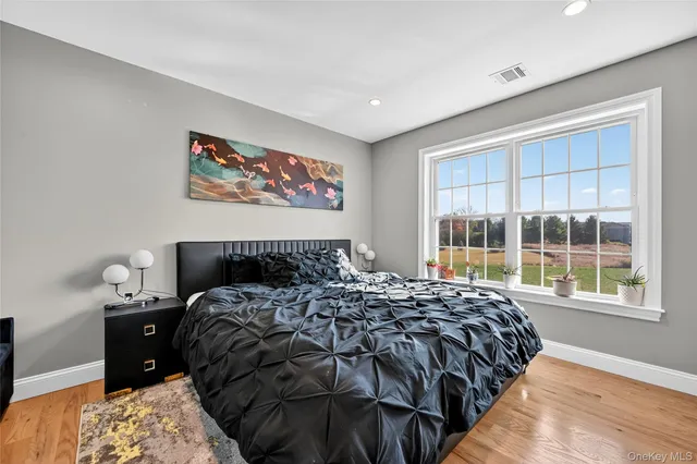 a bed sitting in a bedroom next to a window