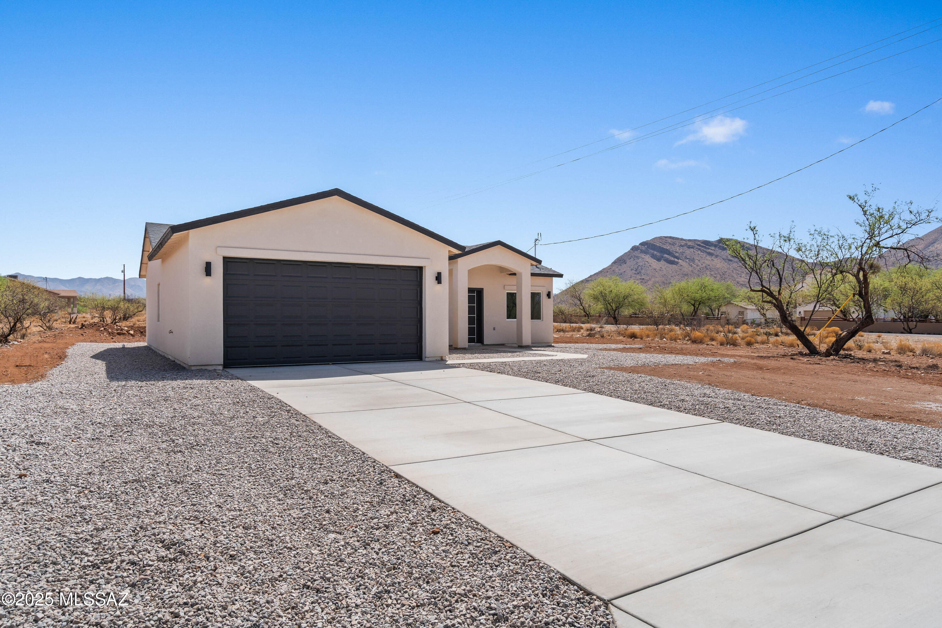 1851 Calle Salmon Rio Rico, AZ 85648 - Photo 3 of 29 a front view of a house with a yard and garage