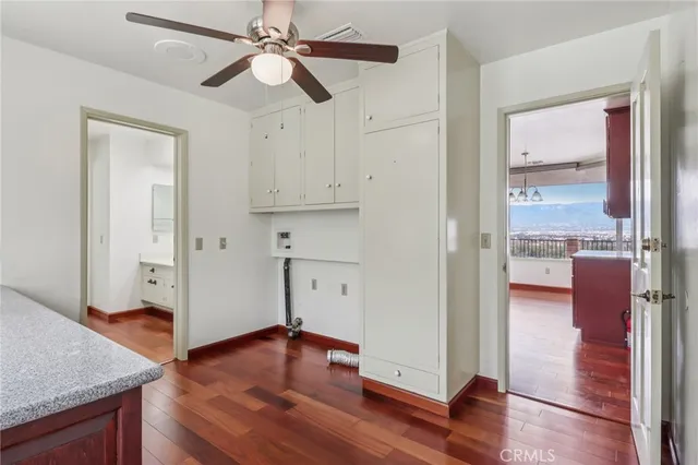 a view of room with wooden floor and fan