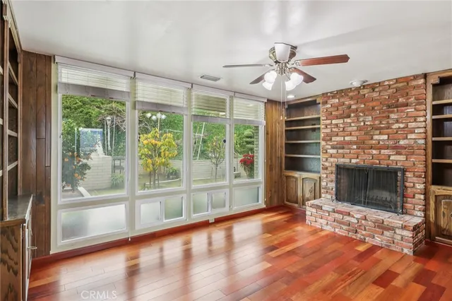 a view of livingroom with hardwood floor and a ceiling fan