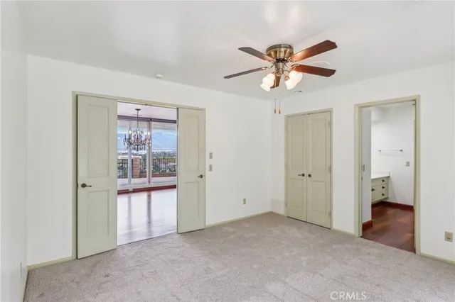 a view of a livingroom with a ceiling fan and window