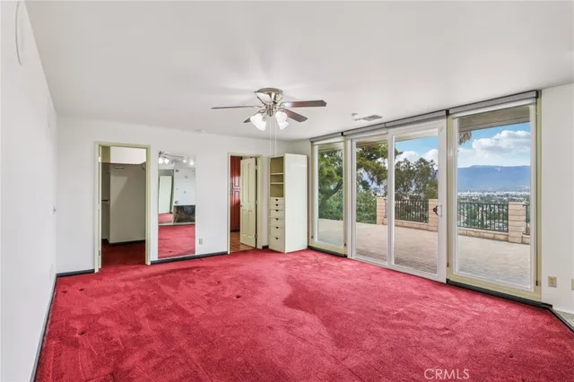 a large bedroom with a bed and a large window