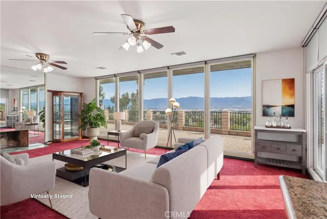 a living room with furniture fireplace and a large window