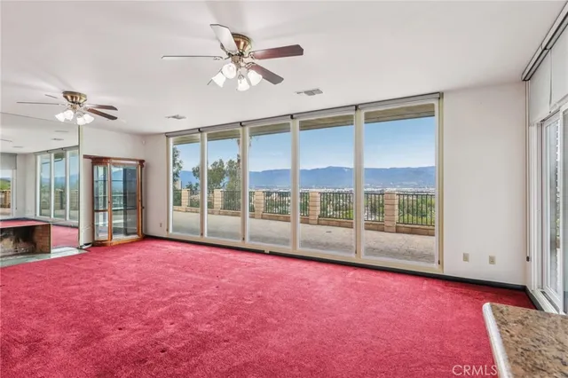 a view of room with window and a ceiling fan