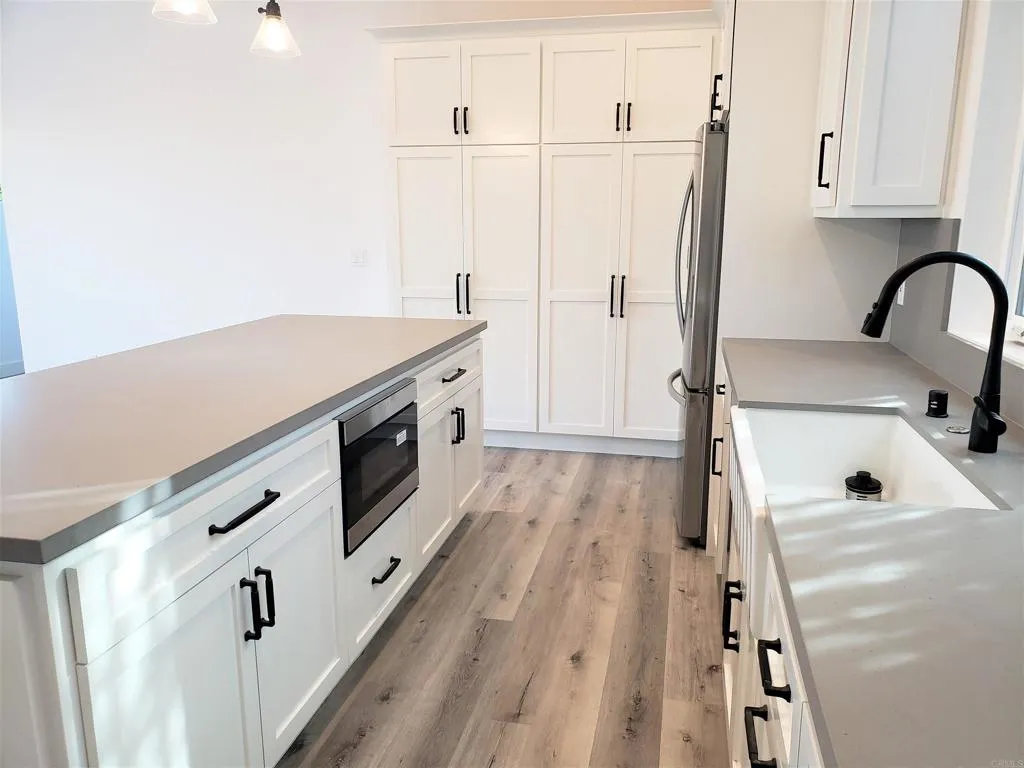 804 Clark Avenue Encinitas, CA 92024 - Photo 36 of 50 a kitchen with a sink a refrigerator and cabinets