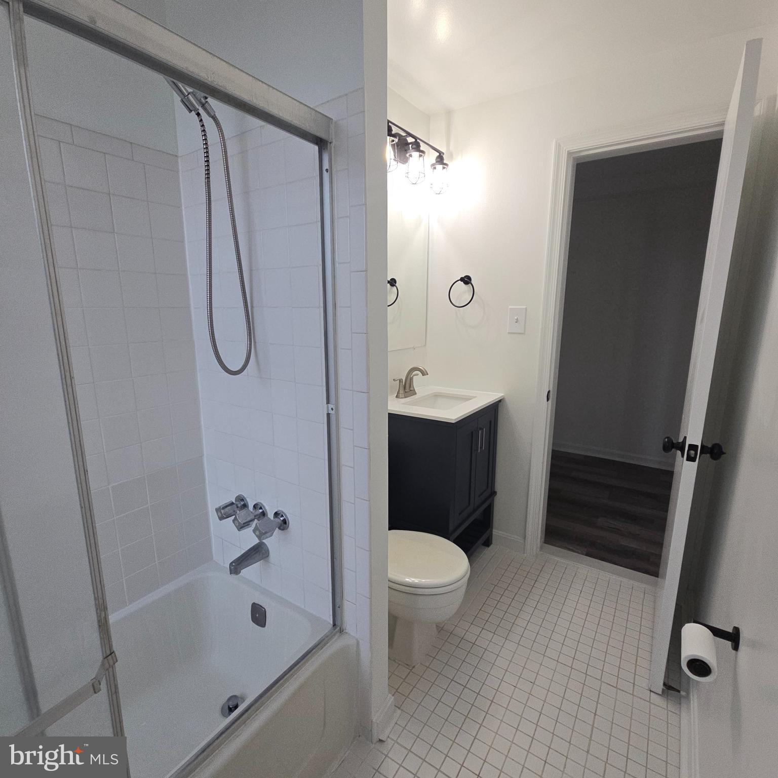1451 Park Road Northwest, Unit 419 Washington, DC 20010 - Photo 11 of 17 a bathroom with a sink a toilet and shower