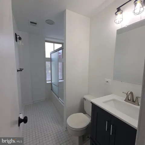 a bathroom with a glass shower door
