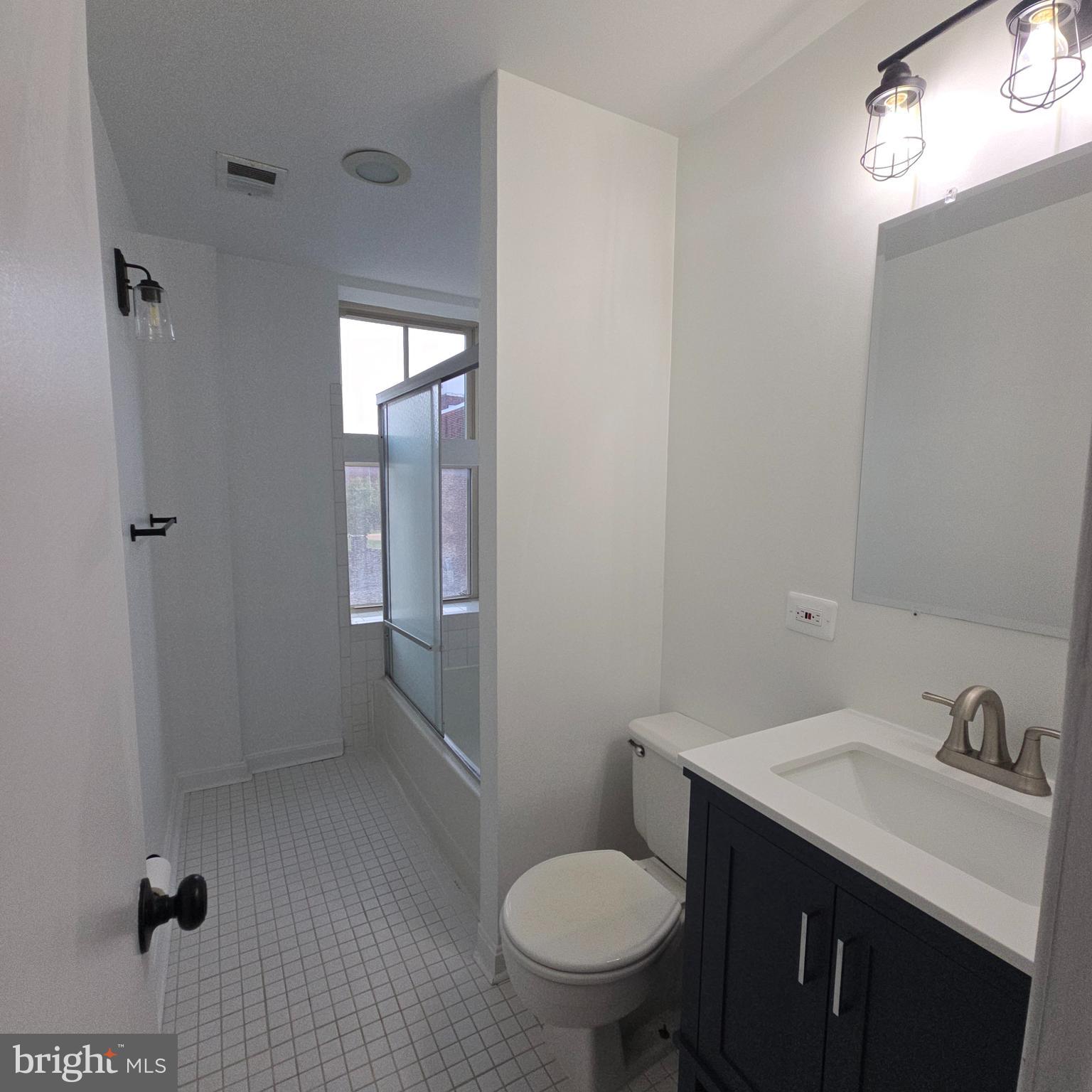 1451 Park Road Northwest, Unit 419 Washington, DC 20010 - Photo 13 of 17 a bathroom with a sink toilet and shower