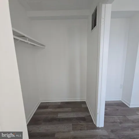 a view of hallway with wooden floor