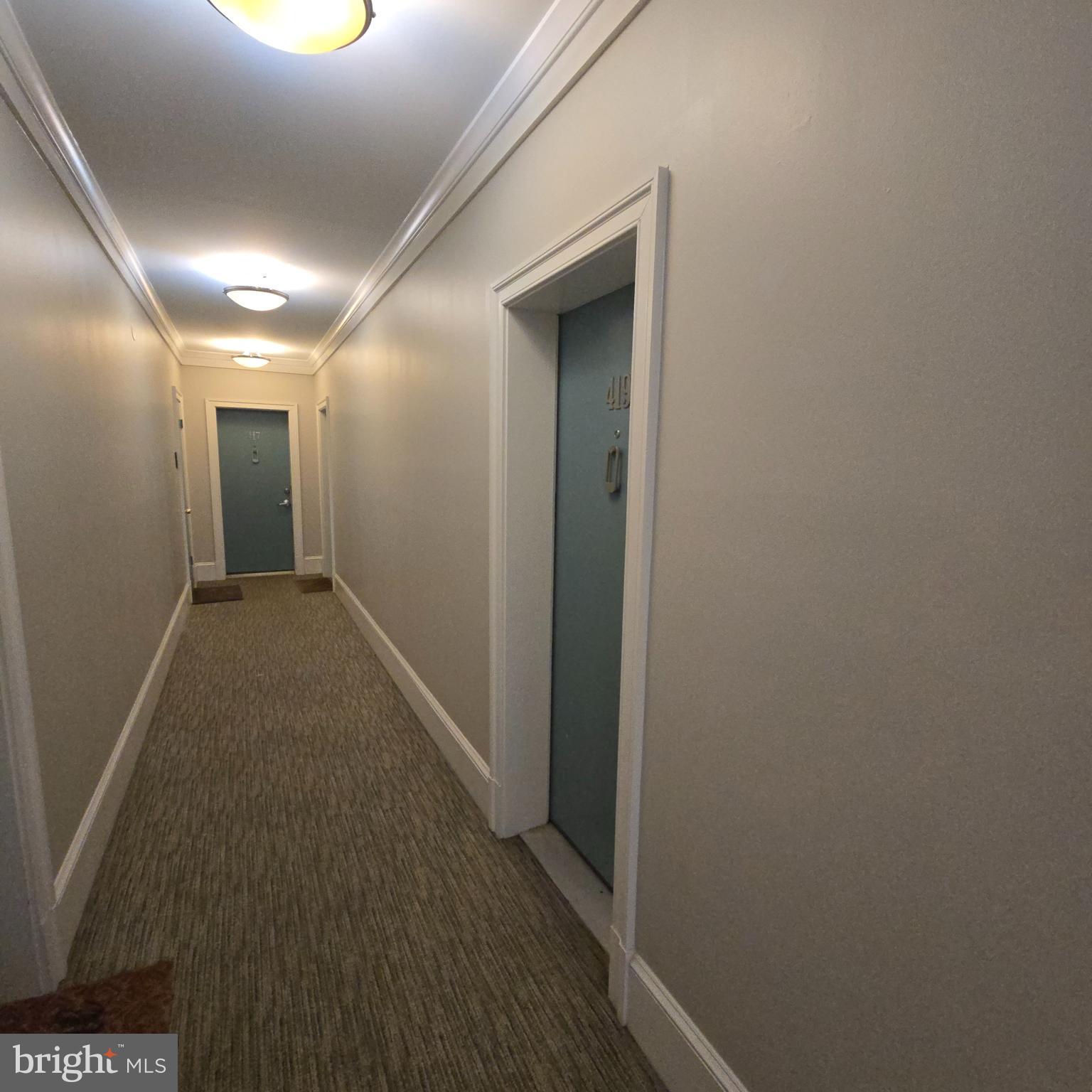 1451 Park Road Northwest, Unit 419 Washington, DC 20010 - Photo 17 of 17 a view of hallway with wooden floor