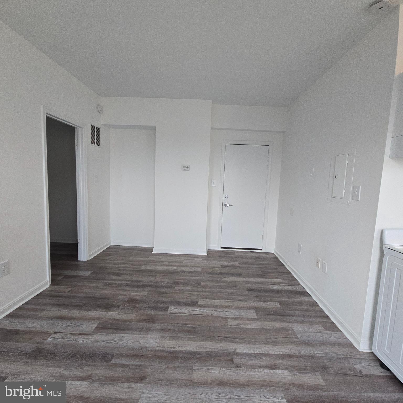 1451 Park Road Northwest, Unit 419 Washington, DC 20010 - Photo 2 of 17 a view of an empty room and wooden floor