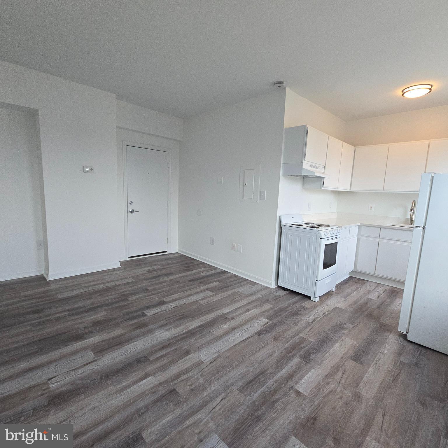 1451 Park Road Northwest, Unit 419 Washington, DC 20010 - Photo 4 of 17 a view of a kitchen with wooden floor