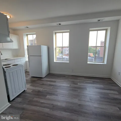 a stove top oven sitting inside of a kitchen