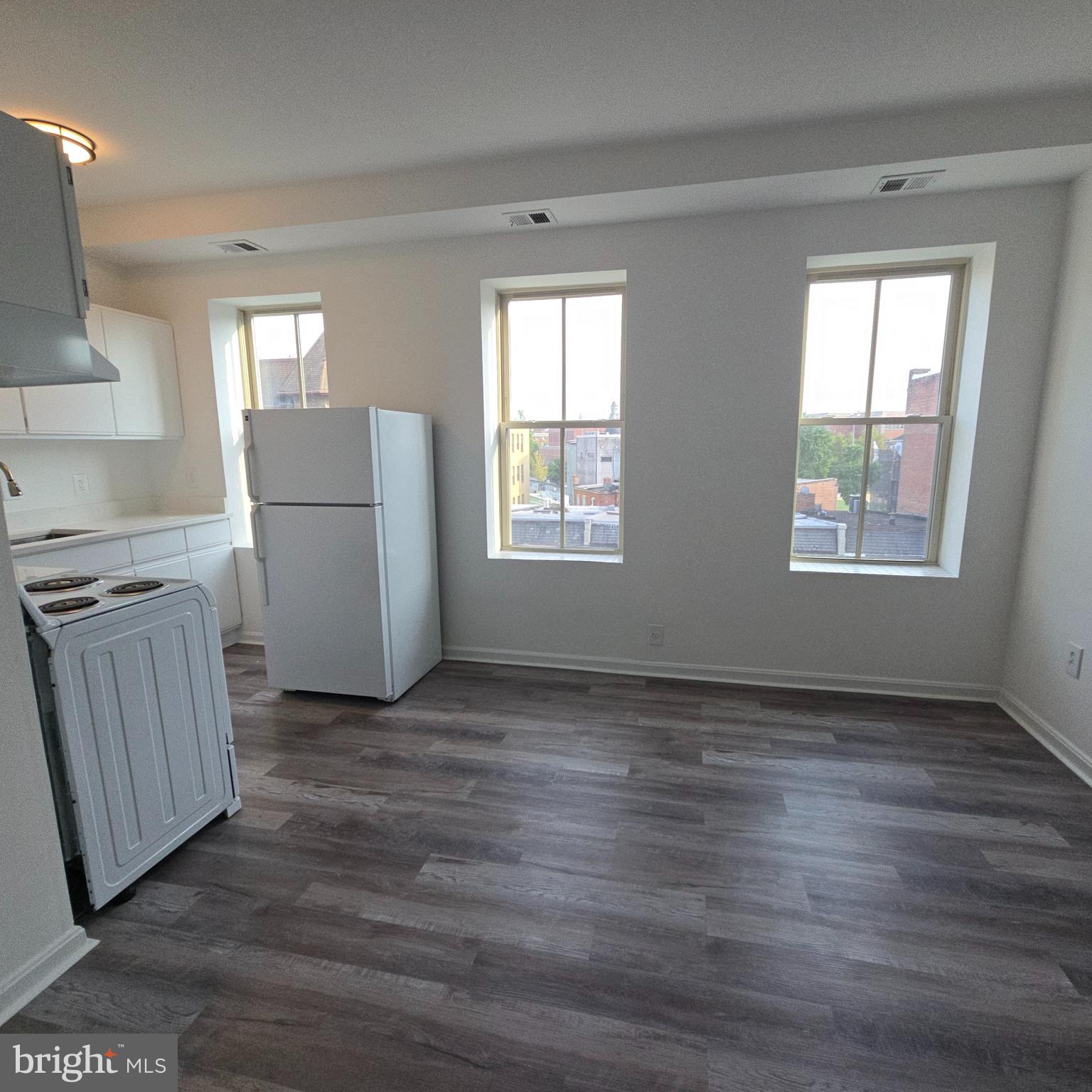 1451 Park Road Northwest, Unit 419 Washington, DC 20010 - Photo 6 of 17 a view of kitchen with furniture and wooden floor