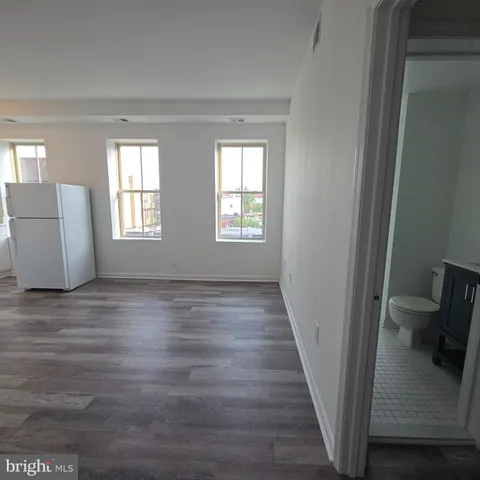 a kitchen with a refrigerator a stove a sink a washer and dryer