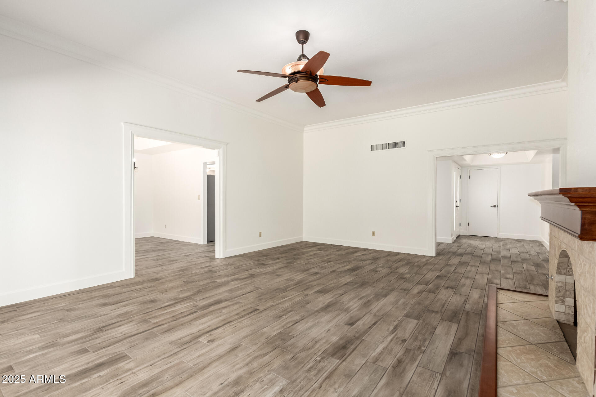 38 East Calavar Road Phoenix, AZ 85022 - Photo 11 of 45 a view of empty room with wooden floor and ceiling fan