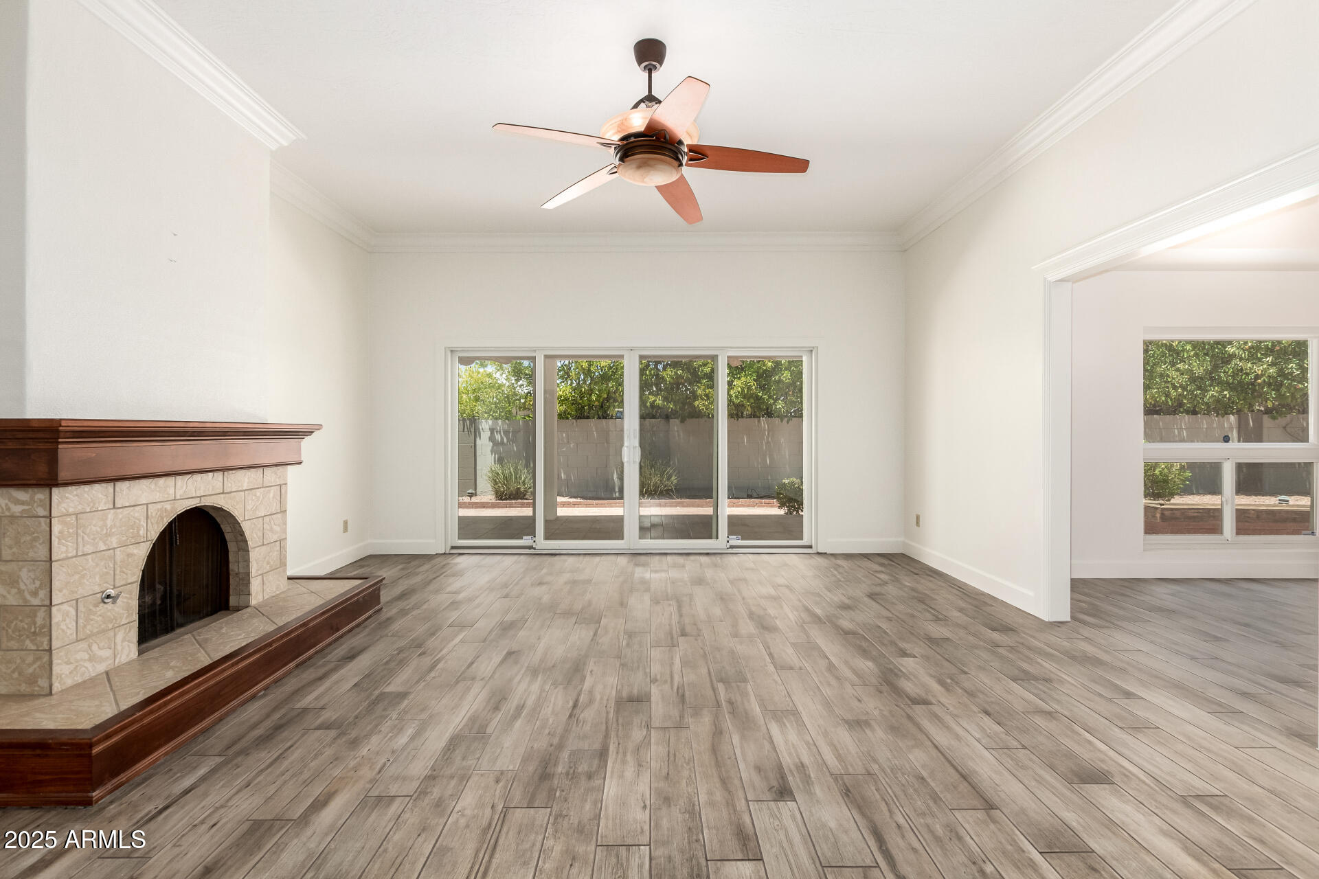 38 East Calavar Road Phoenix, AZ 85022 - Photo 13 of 45 a view of wooden floor fireplace and windows in an empty room